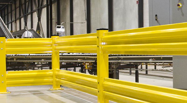 Yellow safety guard rail in a manufacturing facility 